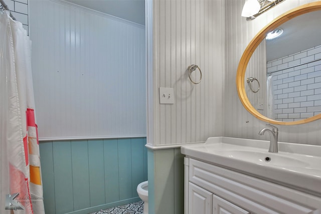 bathroom featuring vanity, crown molding, and toilet