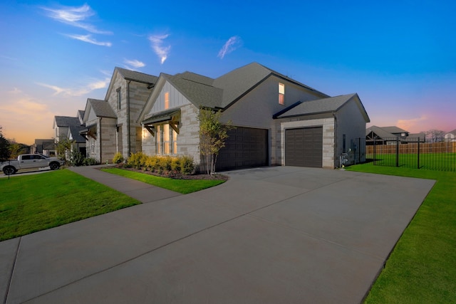 view of front of home with a garage and a yard