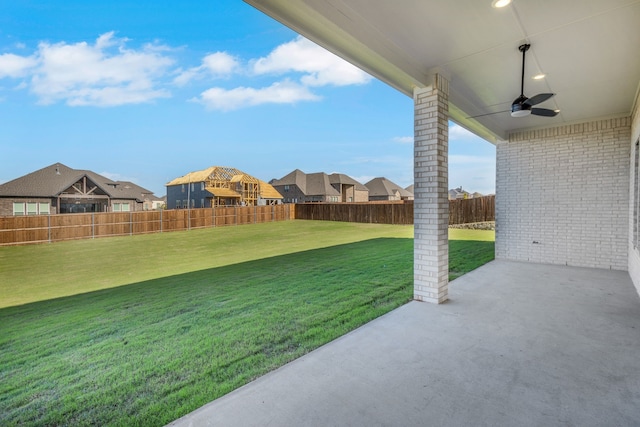 view of yard with ceiling fan and a patio area