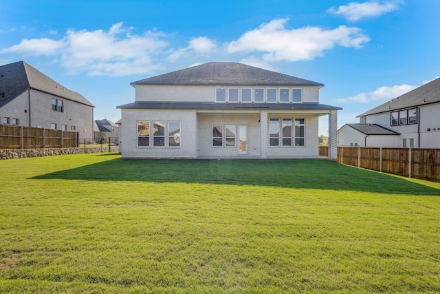 rear view of house with a lawn