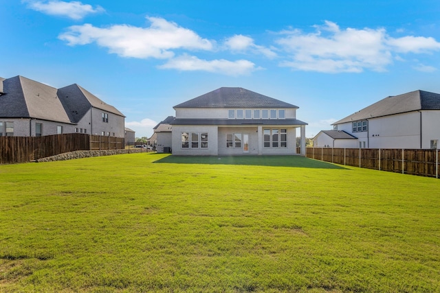 rear view of house with a lawn