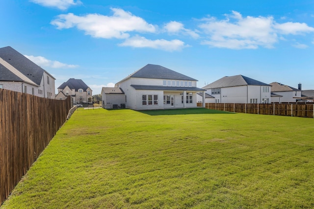 back of house featuring a yard