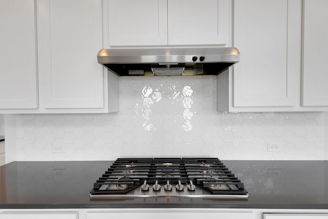 room details featuring white cabinetry, backsplash, exhaust hood, and stainless steel gas stovetop