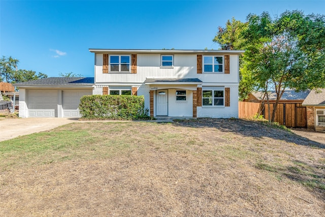 view of front of house with a front yard and a garage