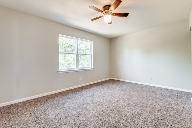 spare room with ceiling fan and carpet