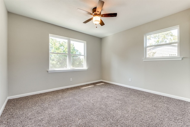 carpeted spare room with ceiling fan