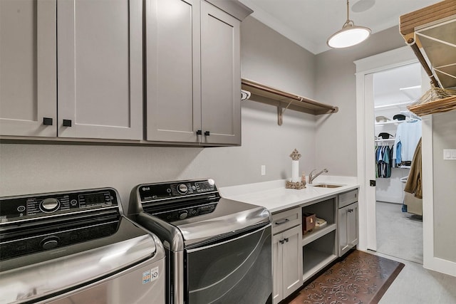 clothes washing area with cabinets, separate washer and dryer, and sink