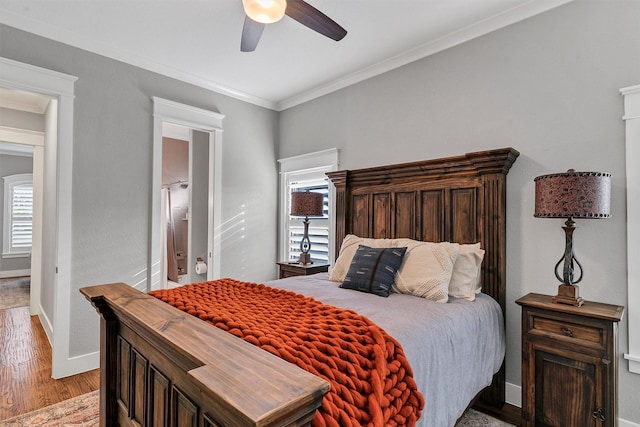 bedroom with ceiling fan, light hardwood / wood-style floors, and crown molding