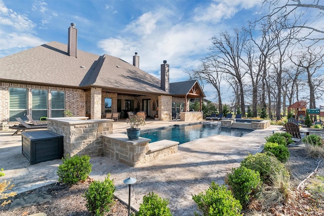 view of pool with a bar, an in ground hot tub, and a patio area