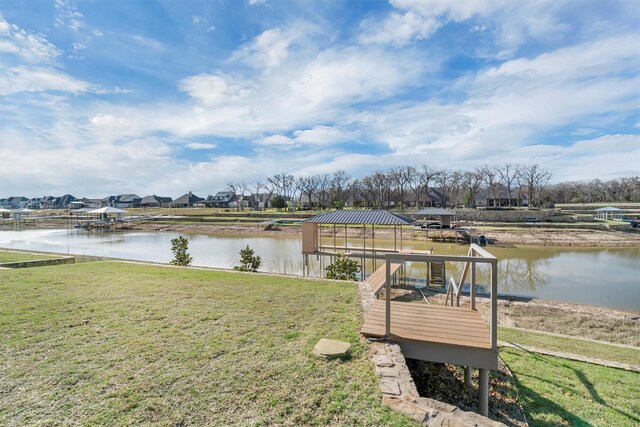 view of dock featuring a lawn, a gazebo, and a water view