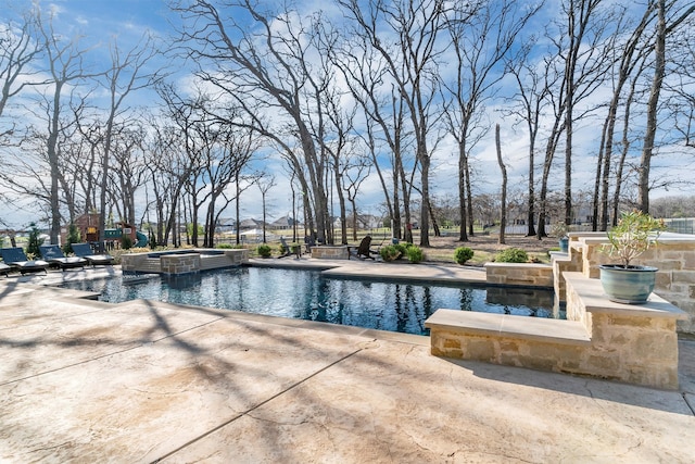 view of swimming pool featuring an in ground hot tub and a patio