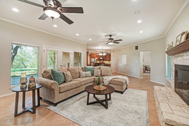 living room with a fireplace, light tile patterned floors, french doors, and crown molding