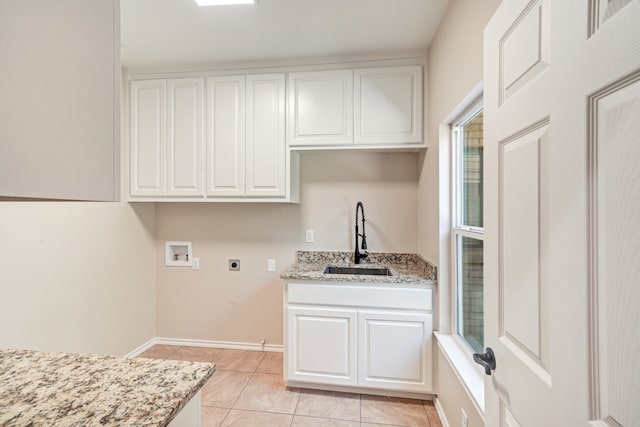 laundry area featuring sink, cabinets, washer hookup, electric dryer hookup, and light tile patterned floors