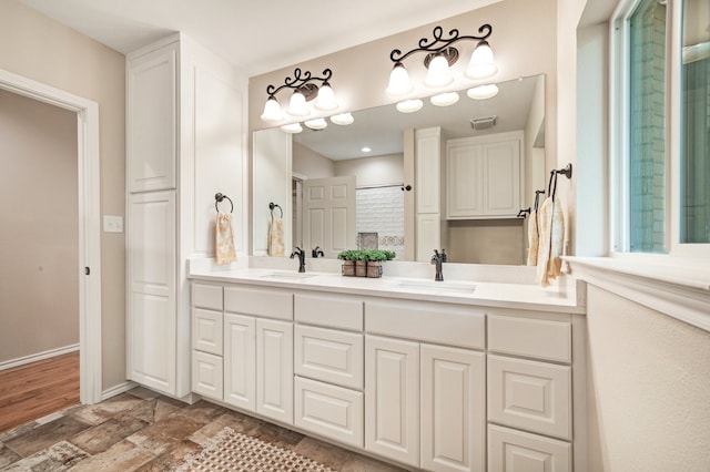 bathroom featuring a shower and vanity