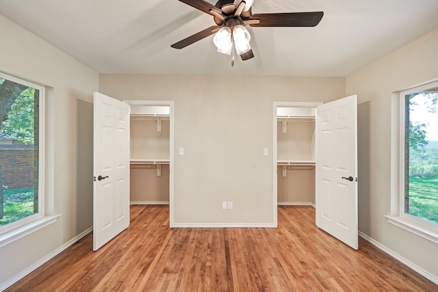 unfurnished bedroom with multiple windows, light hardwood / wood-style flooring, and ceiling fan