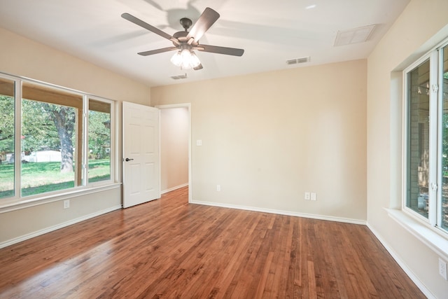 spare room featuring wood-type flooring and ceiling fan