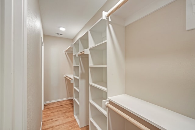 spacious closet featuring light hardwood / wood-style flooring