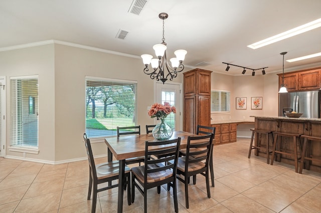 dining space featuring light tile patterned floors, an inviting chandelier, and ornamental molding