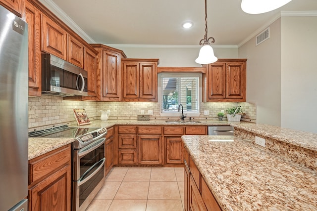 kitchen featuring hanging light fixtures, crown molding, sink, and stainless steel appliances