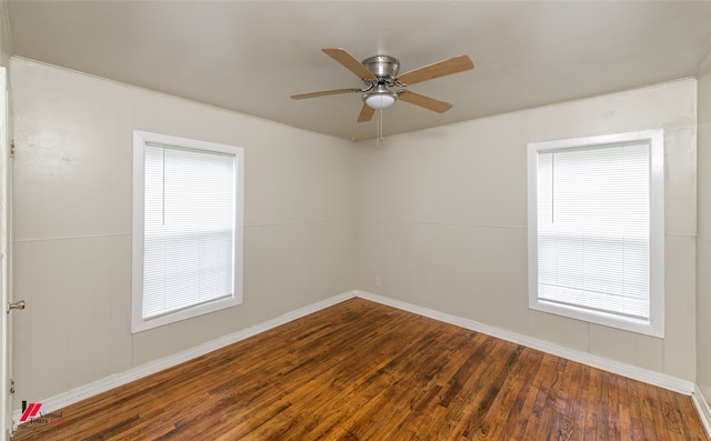 spare room featuring wood-type flooring and ceiling fan