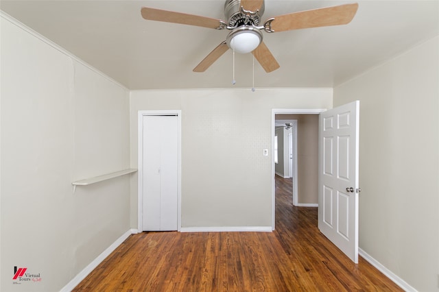 spare room with ceiling fan and dark hardwood / wood-style flooring