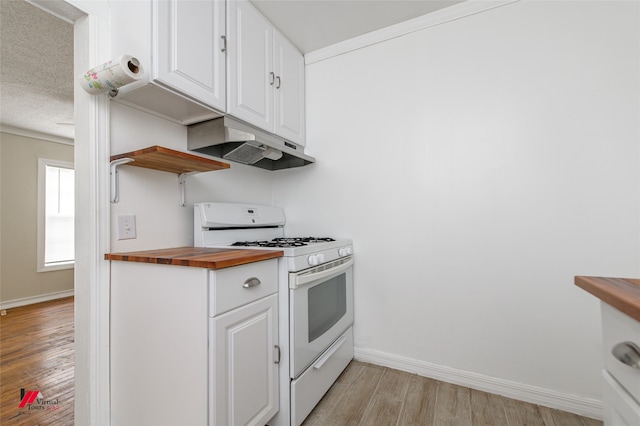 kitchen with light wood-type flooring, white cabinets, white gas range oven, and butcher block countertops