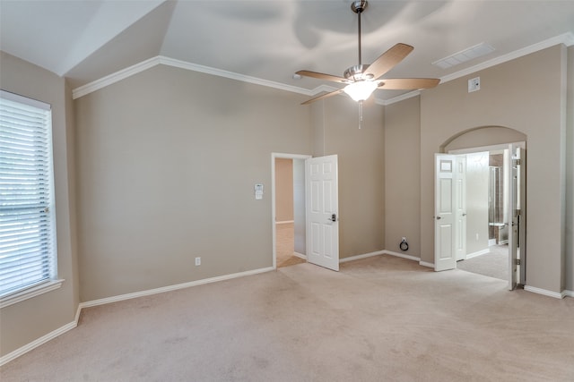 unfurnished room featuring ceiling fan, lofted ceiling, light carpet, and ornamental molding