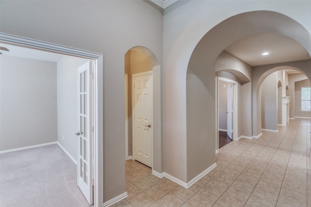 hallway with light colored carpet