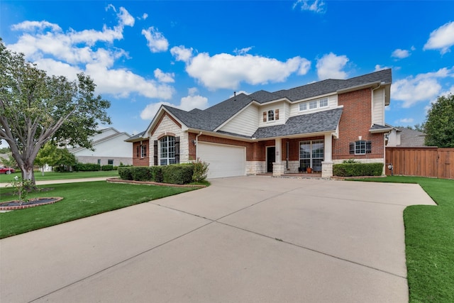 view of front of property with a front yard and a garage