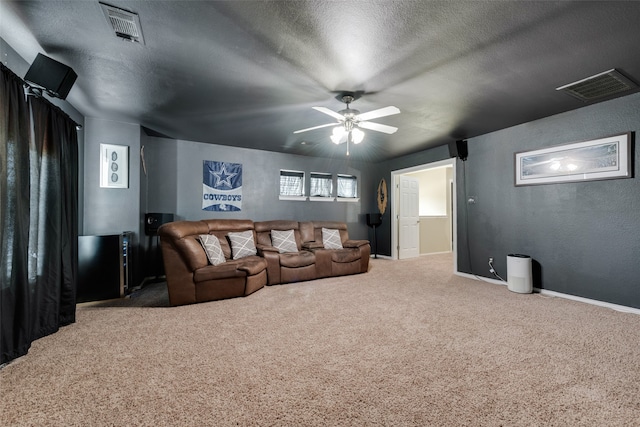 cinema with a textured ceiling, carpet flooring, and ceiling fan