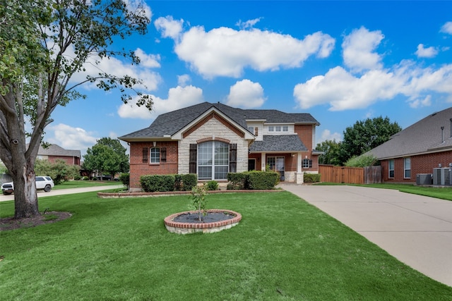 view of front of property featuring cooling unit and a front lawn