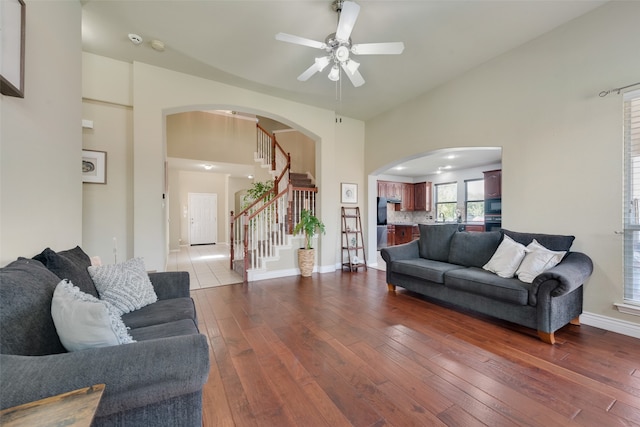 living room featuring high vaulted ceiling, ceiling fan, and hardwood / wood-style flooring