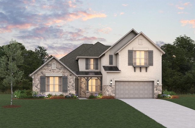 view of front of home featuring a garage and a lawn