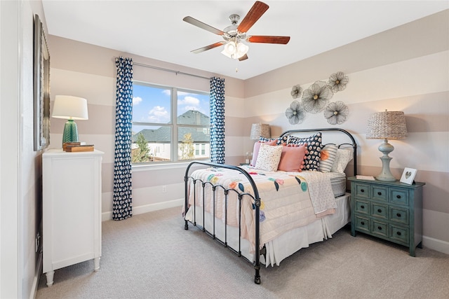 bedroom featuring ceiling fan and light carpet