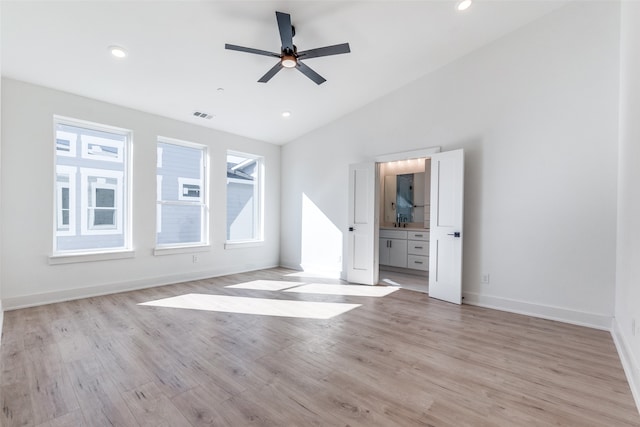 unfurnished living room with ceiling fan, light hardwood / wood-style floors, and lofted ceiling