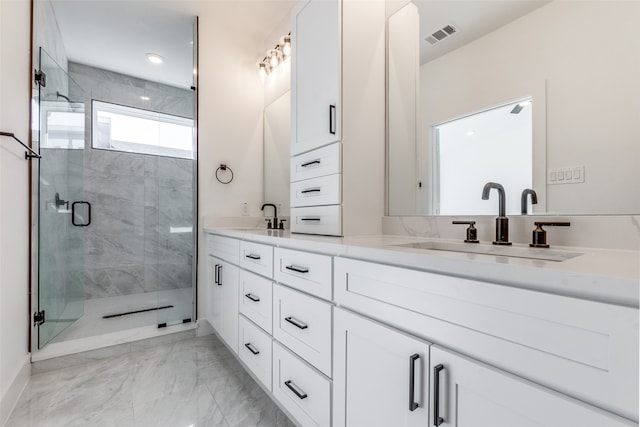 bathroom with a shower with door and vanity