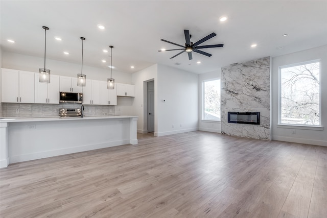 kitchen featuring ceiling fan, white cabinets, pendant lighting, and appliances with stainless steel finishes