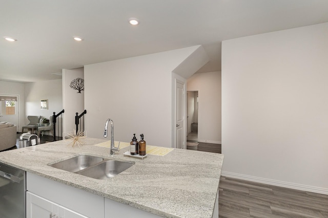 kitchen featuring white cabinetry, dishwasher, light stone countertops, and sink