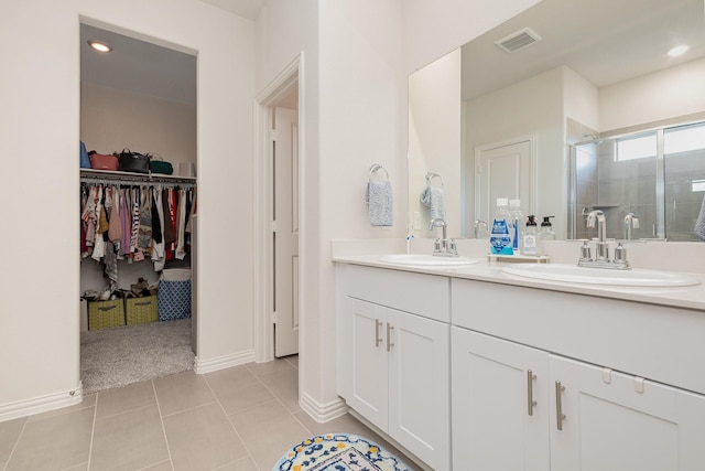 bathroom featuring tile patterned floors, vanity, and walk in shower