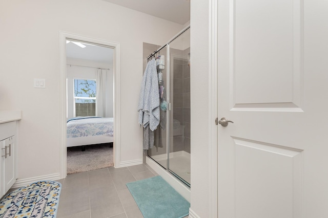 bathroom featuring tile patterned floors, vanity, and walk in shower