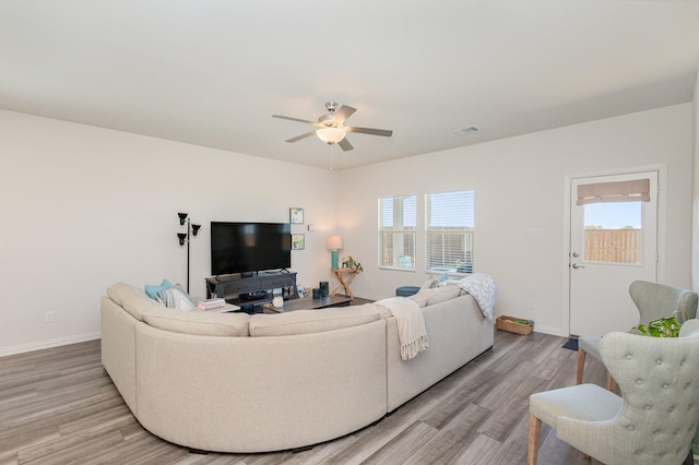 living room with ceiling fan and light hardwood / wood-style floors