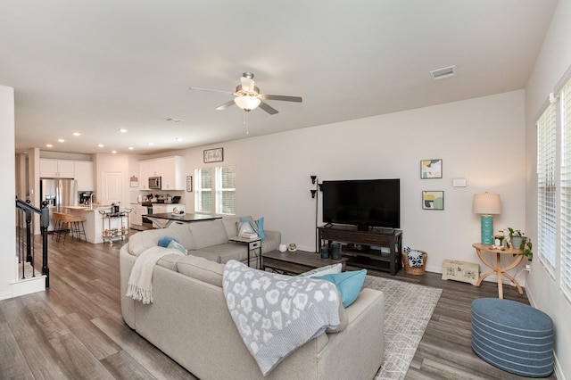 living room featuring ceiling fan and wood-type flooring