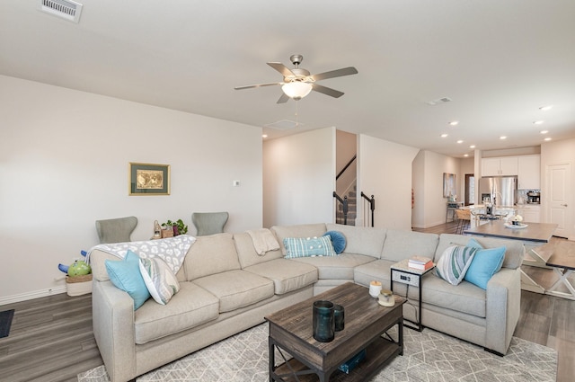 living room featuring ceiling fan and hardwood / wood-style floors