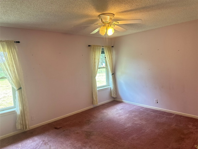 carpeted spare room with a textured ceiling and ceiling fan