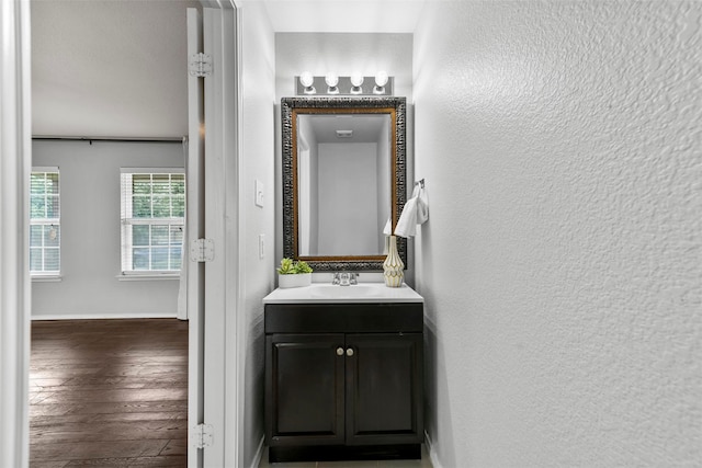 bathroom with vanity and hardwood / wood-style flooring