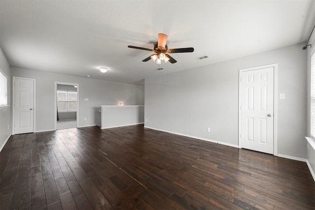 unfurnished room featuring ceiling fan and dark wood-type flooring