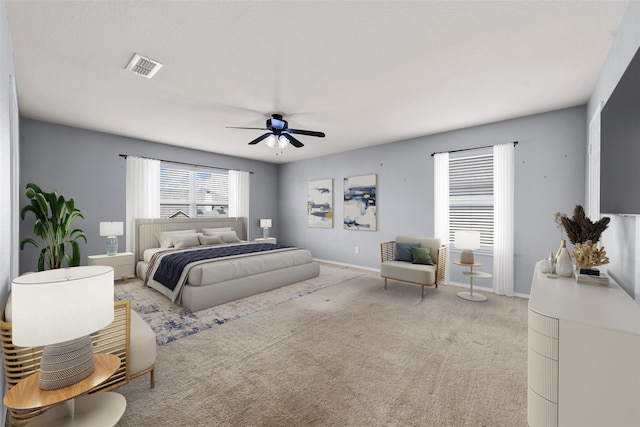 bedroom with light carpet and ceiling fan