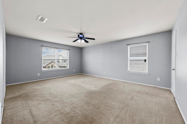 empty room featuring light carpet and ceiling fan