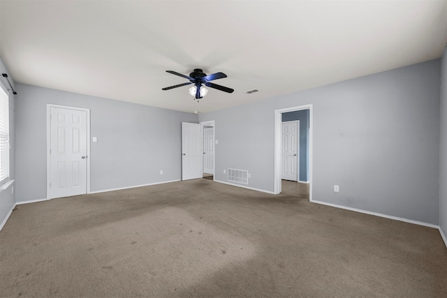 carpeted spare room featuring ceiling fan