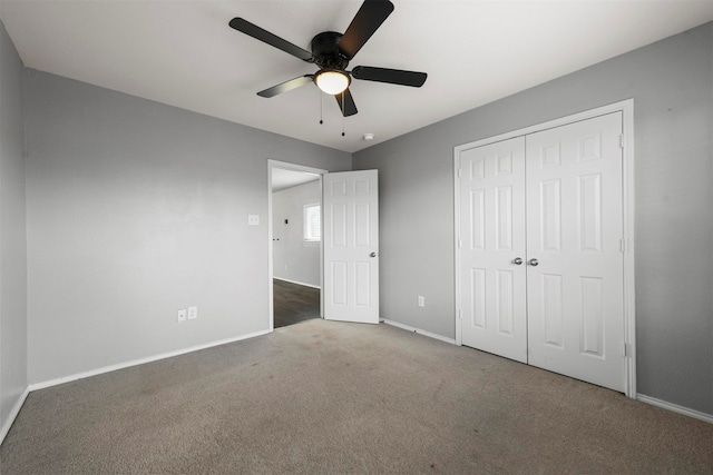 unfurnished bedroom with carpet flooring, ceiling fan, and a closet